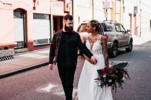 A line beaded wedding gown with slit and red flowers
