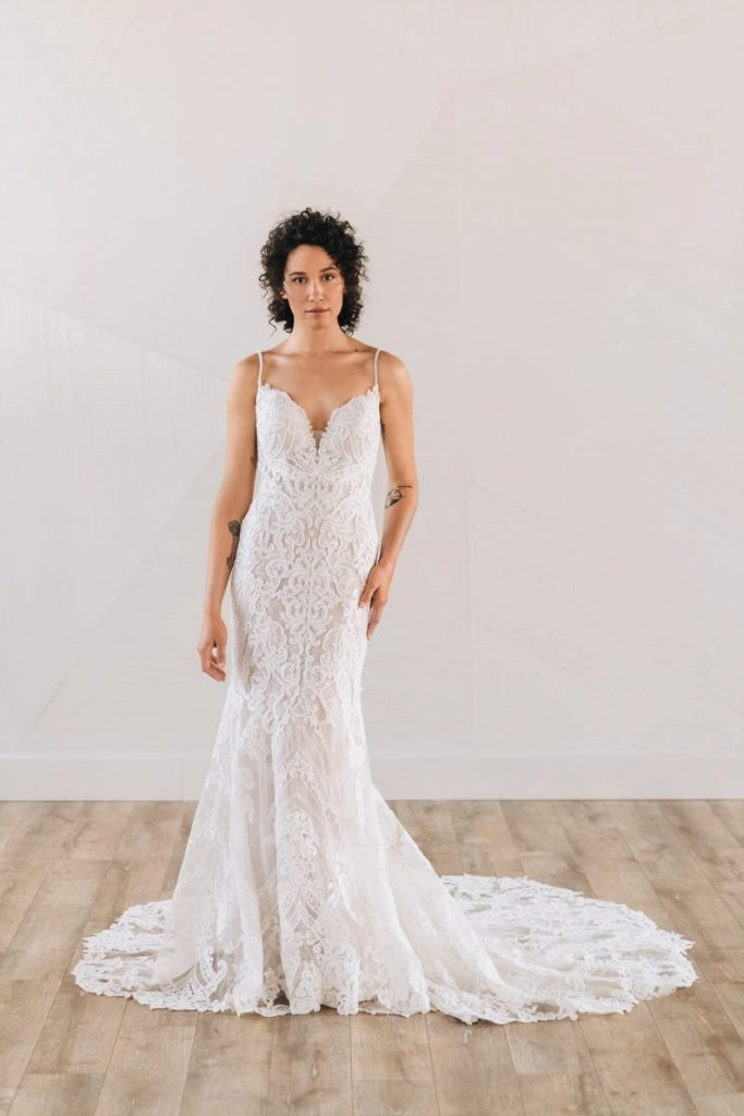 Bride wearing beaded art deco wedding dress with thin straps and deep v neckline