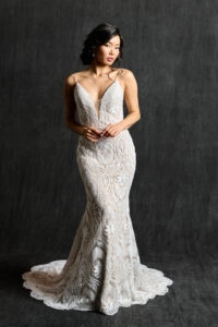 Lace boho sheath wedding gown with deep-V neckline, showcasing its intricate design and elegant style.