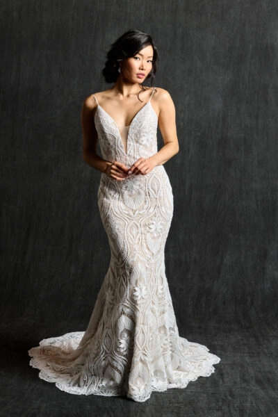 Lace boho sheath wedding gown with deep-V neckline, showcasing its intricate design and elegant style.