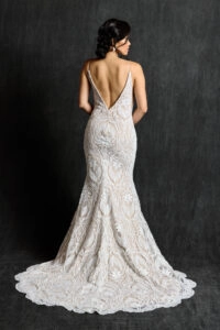 Back view of bride wearing an Art Deco lace bridal gown with a fitted sheath silhouette, deep V back, and intricate lace detailing.