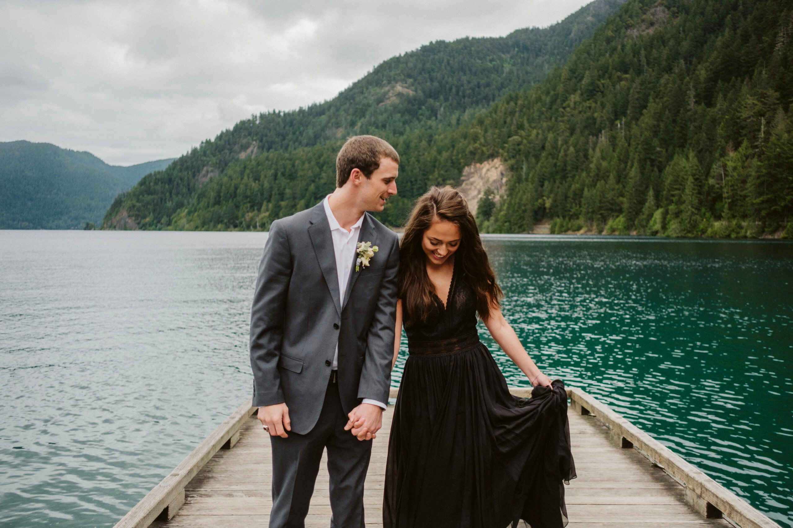 black wedding dress couple on lake dock