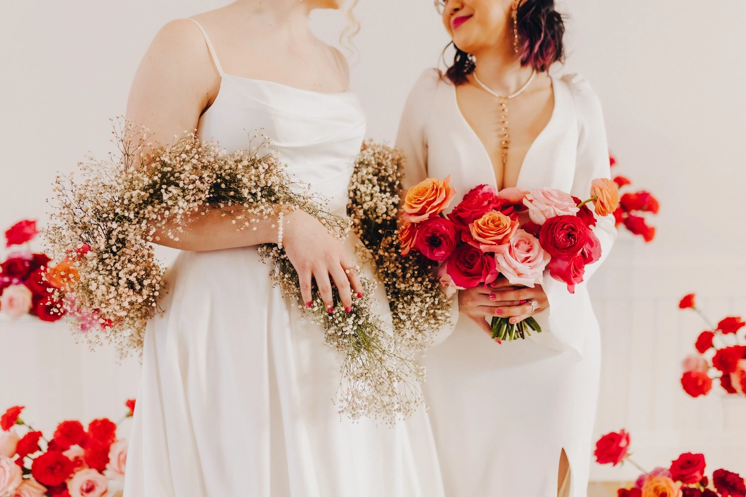 two brides with colorful flowers and simple gowns unique bridal jewelry